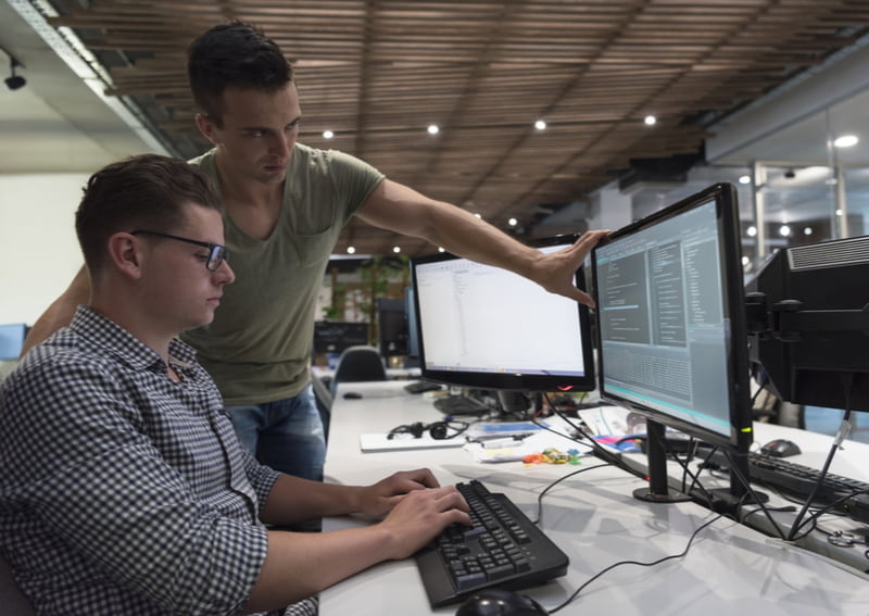 Programmers working as team to find solution to problem