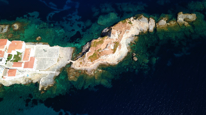 Aerial drone bird's eye view of an island with an old castle